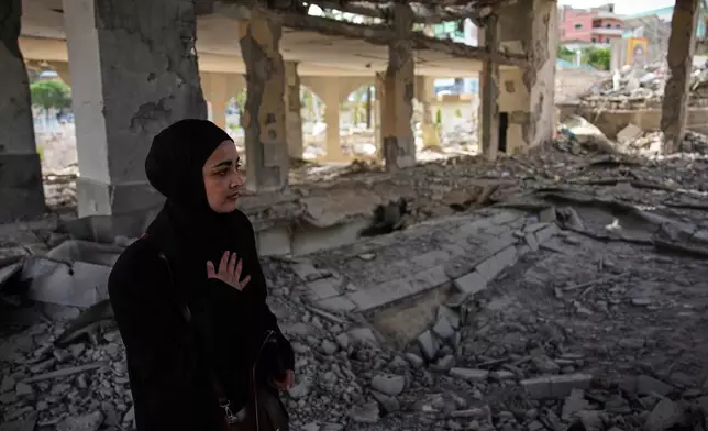 A locals resident walks among debris inside a mosque destroyed in an Israeli airstrike in Jibchit, southern Lebanon, Friday, April 17, 2026, following a ceasefire between Israel and Hezbollah. (AP Photo/Hassan Ammar)