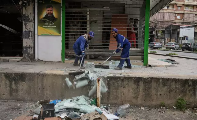 Municipal workers clean the streets in Dahiyeh, Beirut's southern suburbs, Lebanon, Friday, April 17, 2026, following a ceasefire between Israel and Hezbollah. (AP Photo/Bilal Hussein)