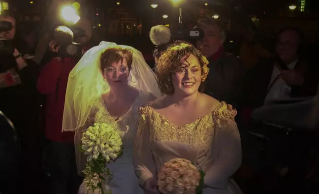 FILE -Helene Faasen, left, and Anne-Marie Thus, who were among four couples to get married under the world's first law allowing same-sex marriages with equal rights. arrive at Amsterdam's City Hall early April 1, 2001. (AP Photo/Peter Dejong, File)
