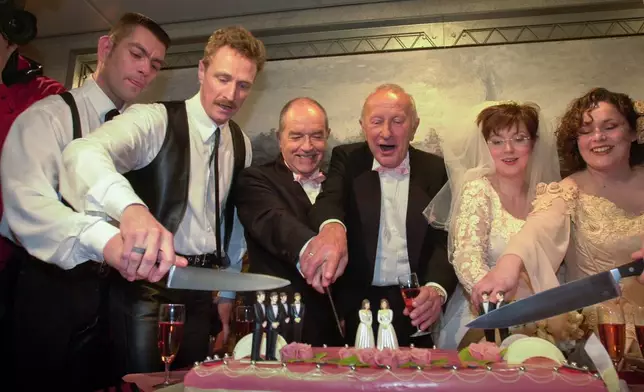 FILE -From left, Peter Wittebrood-Lemke, Frank Wittebrood, Ton Jansen, Louis Rogmans, Helene Faasen and Anne-Marie Thus, the pairs who were among four couples to get married under the world's first law allowing same-sex marriages with equal rights. cut the wedding cake after exchanging vows at Amsterdam's City Hall early April 1, 2001. (AP Photo/Peter Dejong, File)