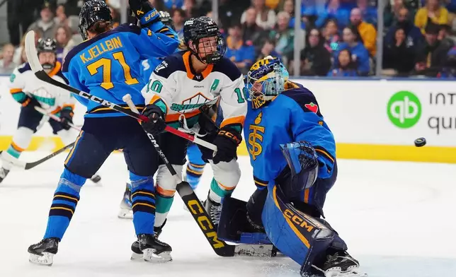 New York Sirens' Sarah Fillier (10) runs into Toronto Sceptres goaltender Raygan Kirk (1) as the puck enters the net and Sceptres' Anna Kjellbin (71) defends during the first period of an PWHL hockey game in Toronto on Tuesday, April 21, 2026. (Frank Gunn/The Canadian Press via AP)