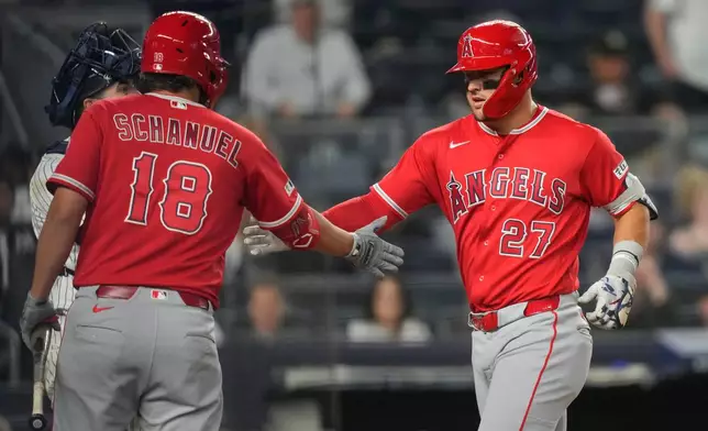 Los Angeles Angels' Mike Trout (27) celebrates with Nolan Schanuel (18) after hitting a two-run home run during the eighth inning of a baseball game against the New York Yankees, Monday, April 13, 2026, in New York. (AP Photo/Yuki Iwamura)