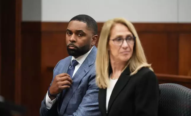 Former Michigan football coach Sherrone Moore appears in court with his attorney Ellen Michaels, Tuesday, April 14, 2026, in Ann Arbor, Mich. (AP Photo/Paul Sancya)