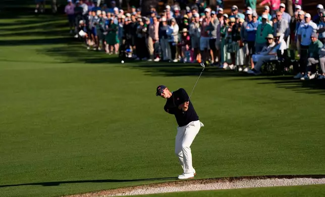 Adam Scott, of Australia, chips to the green on the second hole during the second round of the Masters golf tournament at the Augusta National Golf Club, Friday, April 10, 2026, in Augusta, Ga. (AP Photo/David J. Phillip)