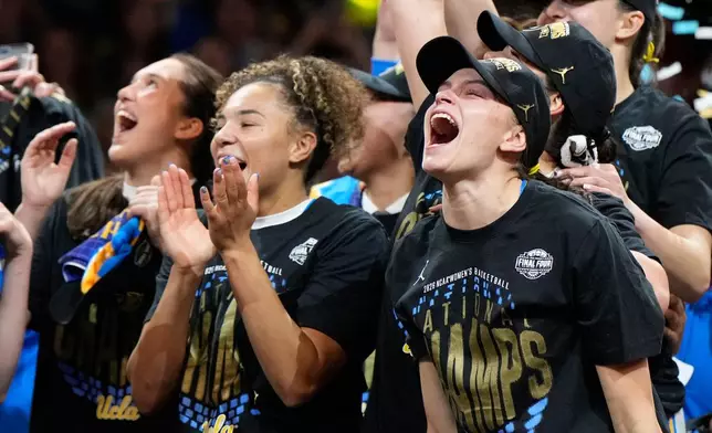 UCLA guard Gabriela Jaquez (11) celebrates with teammates after UCLA defeated South Carolina in the women's National Championship Final Four NCAA college basketball tournament game, Sunday, April 5, 2026, in Phoenix. (AP Photo/Ross D. Franklin)