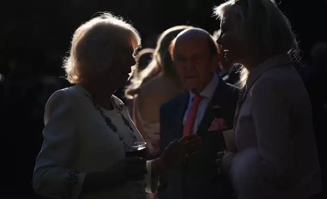 Britain's Queen Camilla speaks with guests during a garden party at the British Embassy, Monday, April 27, 2026, in Washington. (AP Photo/Julia Demaree Nikhinson, Pool)