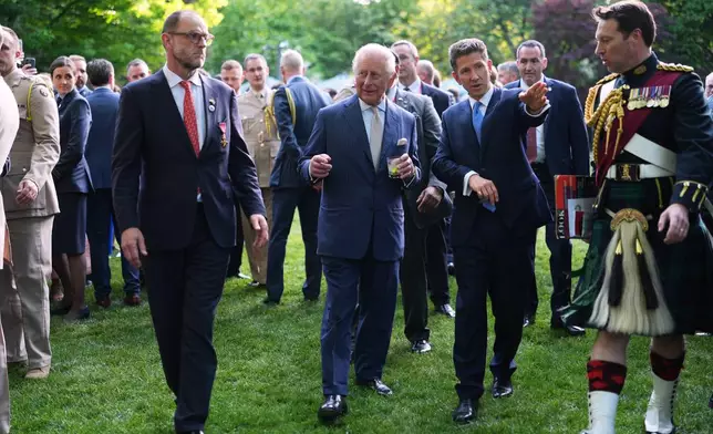 Britain's King Charles III and British Ambassador to the U.S. Christian Turner, right, attend a garden party at the British Embassy, Monday, April 27, 2026, in Washington. (AP Photo/Julia Demaree Nikhinson, Pool)