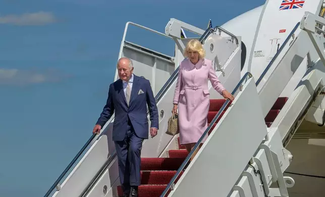 King Charles III, left, and Queen Camilla arrive at Joint Base Andrews, Md., Monday, April 27, 2026. (AP Photo/Rod Lamkey, Jr.)