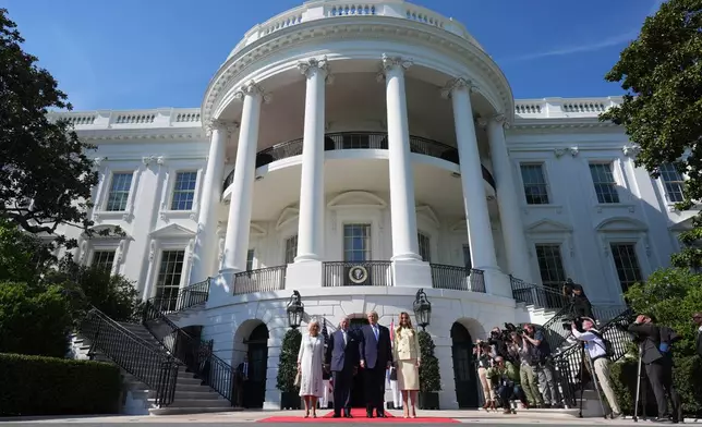 President Donald Trump and first lady Melania Trump greet Britain's King Charles III and Queen Camilla as they arrive at the White House, Monday, April 27, 2026, in Washington. (AP Photo/Alex Brandon)