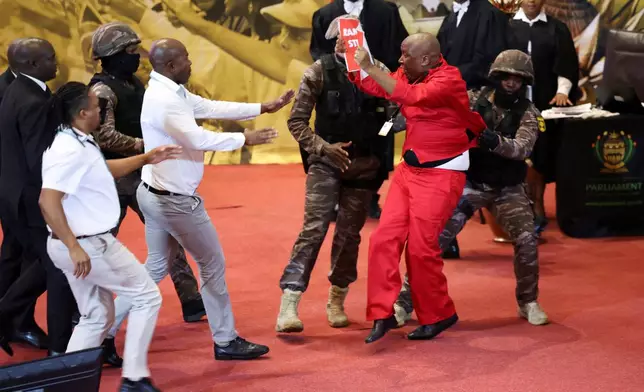 FILE - Opposition Economic Freedom Fighters party leader Julius Malema, center right, is removed by presidential task force as South African President Cyril Ramaphosa attempts to deliver his State of the Nation address to MP's in Cape Town, South Africa, on Feb. 9, 2023. (Esa Alexander/Pool Photo via AP, File)