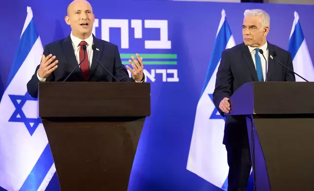 Former Israeli prime ministers Naftali Bennett, left, and Yair Lapid hold a joint press conference announcing that their parties will run together in the upcoming elections, in Herzliya, Israel, Sunday, April 26, 2026. (AP Photo/Ariel Schalit)