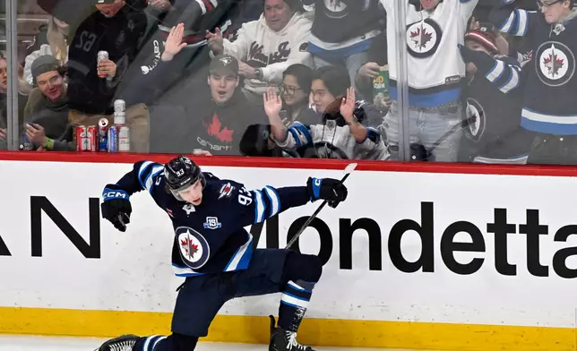 Winnipeg Jets' Brad Lambert (93) celebrates his goal against the Seattle Kraken during the third period of an NHL hockey game, in Winnipeg, Manitoba, Monday, April 6, 2026. (Fred Greenslade/The Canadian Press via AP)