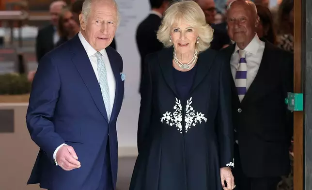 Britain's King Charles and Queen Camilla attend a presentation on the final design for the national memorial to Queen Elizabeth II at the British Museum, on the 100th anniversary of the late queen's birth, in London, Tuesday, April 21, 2026. (Toby Melville/Pool Photo via AP)