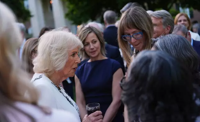 Queen Camilla greets guests during a garden party at the British Embassy, Monday, April 27, 2026, in Washington. (AP Photo/Julia Demaree Nikhinson, Pool)