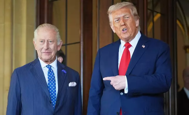 FILE - President Donald Trump gestures next to Britain's King Charles III before leaving Windsor Castle, Windsor, England, Sept. 18, 2025. (AP Photo/Evan Vucci, file)