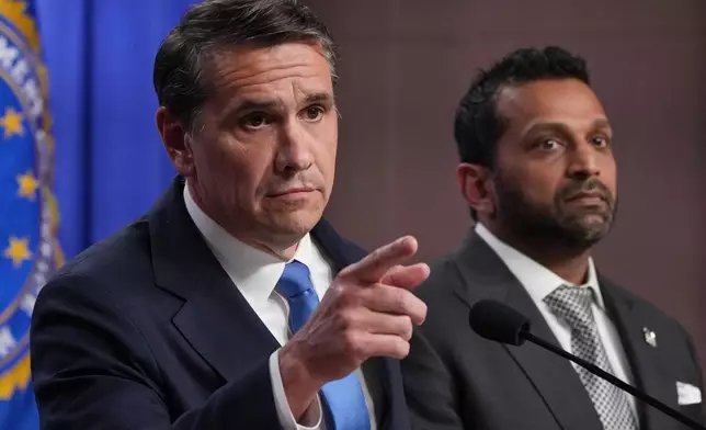 Acting Attorney General Todd Blanche speaks as FBI Director Kash Patel listens during a news conference at the Justice Department, Tuesday, April 21, 2026, in Washington. (AP Photo/Jacquelyn Martin)