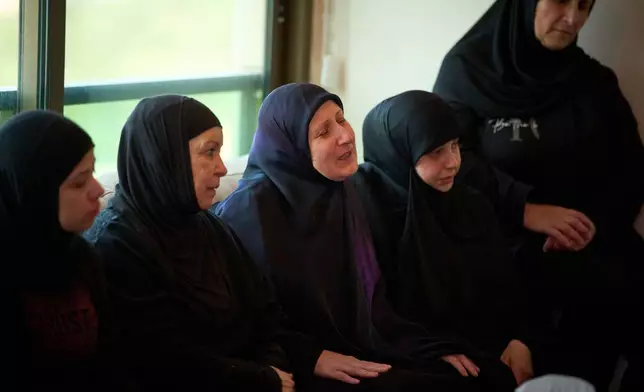 Ahlam Badawi, 51, center, mother of Hassan Ali Badawi, 31, a paramedic of the Lebanese Red Cross killed in a Israeli strike, cries during his funeral in Choueifat, Lebanon, Monday, April 13, 2026. (AP Photo/Emilio Morenatti)