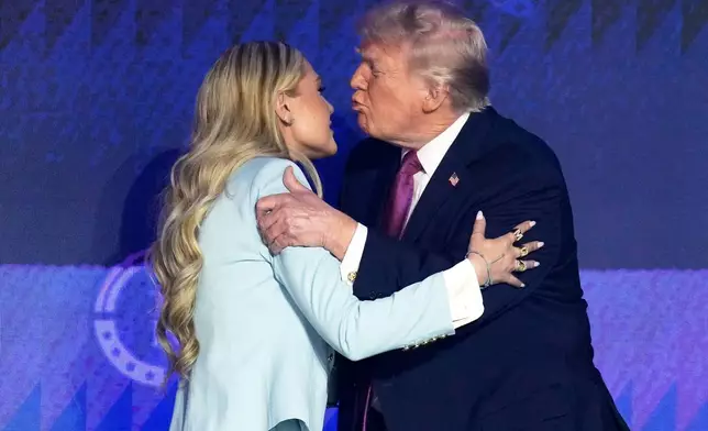 President Donald Trump greets Turning Point CEO Erika Kirk at a Turning Point USA event Friday, April 17, 2026, in Phoenix. (AP Photo/Ross D. Franklin)