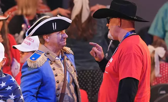 People talk after President Donald Trump spoke at a Turning Point USA event at Dream City Church, Friday, April 17, 2026, in Phoenix. (AP Photo/Ross D. Franklin)