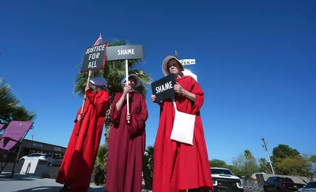 Protesters gather prior to a Turning Point USA event where President Donald Trump is scheduled to speak Friday, April 17, 2026, in Phoenix. (AP Photo/Ross D. Franklin)