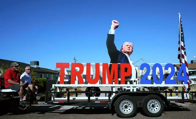 President Donald Trump supporters sit on a tailgate near the venue where the president is scheduled to speak later, Friday, April 17, 2026, in Phoenix. (AP Photo/Ross D. Franklin)