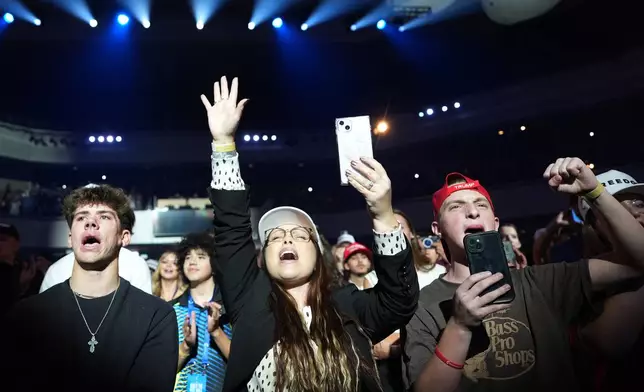 People react as President Donald Trump speaks at a Turning Point USA event at Dream City Church, Friday, April 17, 2026, in Phoenix. (AP Photo/Alex Brandon)