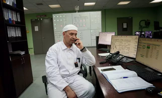 Serhii Bokov, senior manager of operations for the New Safe Confinement structure, which was built to prevent radiation leaks from the damaged reactor at the Chernobyl nuclear power plant in Ukraine, speaks on the phone on April 6, 2026. (AP Photo/Evgeniy Maloletka)