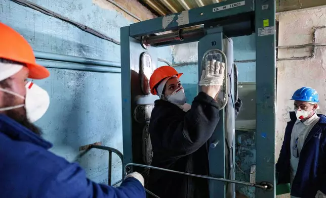 A worker passes through a radiation inspection point at the Chernobyl nuclear power plant in Ukraine on April 6, 2026. (AP Photo/Evgeniy Maloletka)