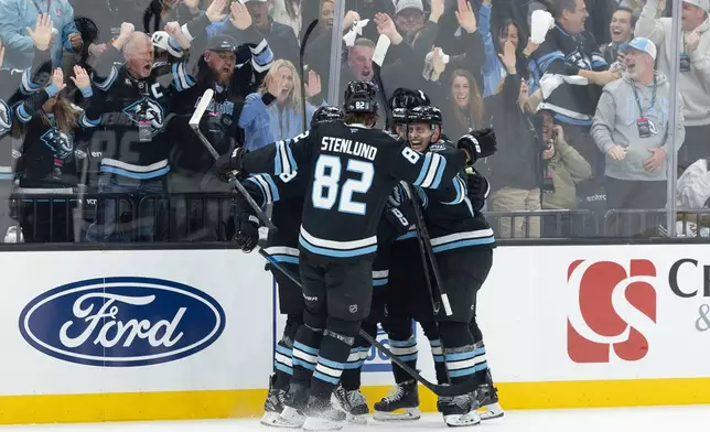 Utah Mammoth celebrate after a goal against the Vegas Golden Knights during the first period of Game 3 of the first round in a NHL hockey Stanley Cup playoff series, Friday, April 24, 2026, in Salt Lake City. (AP Photo/Melissa Majchrzak)