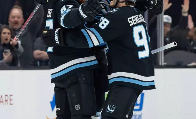 Utah Mammoth center Clayton Keller (9) celebrates a goal with teammates against the Vegas Golden Knights during the second period of Game 3 of the first round NHL hockey Stanley Cup playoff series, Friday, April 24, 2026, in Salt Lake City. (AP Photo/Melissa Majchrzak)