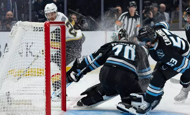 Utah Mammoth goaltender Karel Vejmelka (70) blocks a shot by Vegas Golden Knights center Brett Howden (21) during the second period of Game 3 of the first round in an NHL hockey Stanley Cup playoff series, Friday, April 24, 2026, in Salt Lake City. (AP Photo/Melissa Majchrzak)