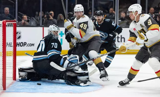 Vegas Golden Knights center Jack Eichel (9) scores against Utah Mammoth goaltender Karel Vejmelka (70) during the second period of Game 3 of the first round in an NHL hockey Stanley Cup playoff series, Friday, April 24, 2026, in Salt Lake City. (AP Photo/Melissa Majchrzak)