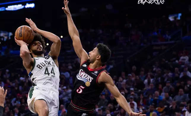 Milwaukee Bucks small forward Andre Jackson Jr., left, looks to shoot against Philadelphia 76ers shooting guard Quentin Grimes, right, during the first half of an NBA basketball game, Sunday, April 12, 2026, in Philadelphia. (AP Photo/Chris Szagola)