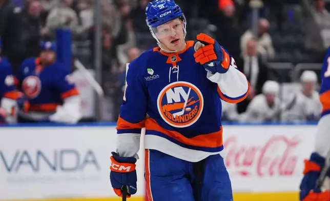 New York Islanders' Emil Heineman (51) celebrates after scoring a goal during the second period of an NHL hockey game against the Toronto Maple Leafs Thursday, April 9, 2026, in Elmont, N.Y. (AP Photo/Frank Franklin II)