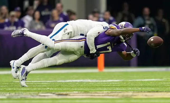 FILE - Indianapolis Colts cornerback Stephon Gilmore (5) breaks up a pass intended for Minnesota Vikings wide receiver K.J. Osborn (17) during the first half of an NFL football game, Dec. 17, 2022, in Minneapolis. (AP Photo/Abbie Parr, File)