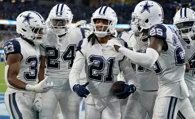 FILE - Dallas Cowboys cornerback Stephon Gilmore (21) celebrates with his teammates after intercepting a pass during the fourth quarter of an NFL football game against the Los Angeles Chargers, Oct. 16, 2023, in Inglewood, Calif. (AP Photo/Ashley Landis, File)