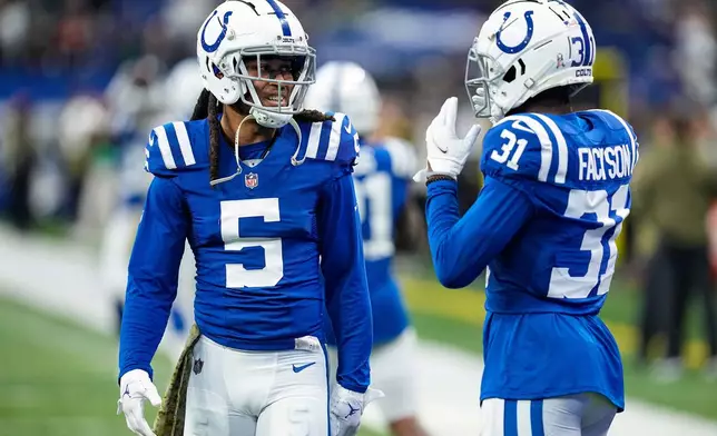 FILE - Indianapolis Colts cornerback Stephon Gilmore (5) talks with cornerback Brandon Facyson (31) before an NFL football game, in Indianapolis, Nov. 20, 2022. (AP Photo/Darron Cummings, File)
