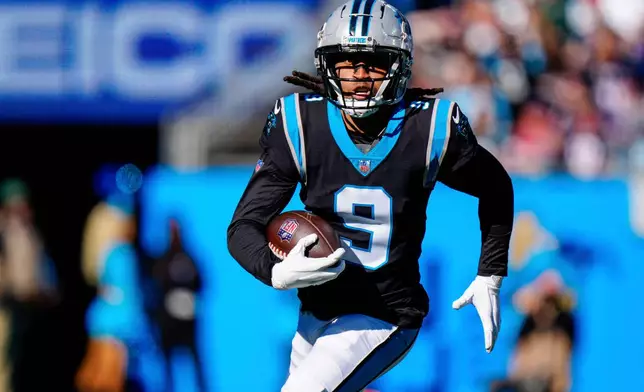 FILE - Carolina Panthers' Stephon Gilmore runs after an interception against the New England Patriots during the first half of an NFL football game Nov. 7, 2021, in Charlotte, N.C. (AP Photo/Jacob Kupferman, File)
