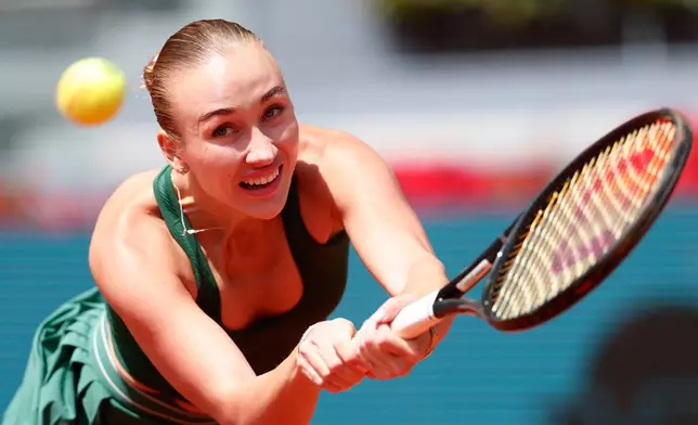 Anastasia Potapova of Russia returns the ball to Karolina Pliskova of the Czech Republic during the Madrid Open tennis tournament in Madrid, Wednesday, April 29, 2026. (AP Photo/Pablo Garcia)
