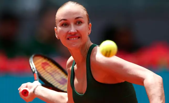 Anastasia Potapova of Russia returns the ball to Karolina Pliskova of the Czech Republic during the Madrid Open tennis tournament in Madrid, Wednesday, April 29, 2026. (AP Photo/Pablo Garcia)