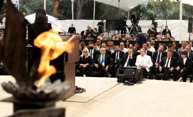 Israel's Prime Minister Benjamin Netanyahu, centre second from left, his wife Sara, centre left, and Israel's President Isaac Herzog, fourth from right, attend a ceremony commemorating Israel's Remembrance Day for fallen soldiers, or Yom HaZikaron, at the Military Cemetery on Mount Herzl in Jerusalem, Tuesday April 21, 2026. (Ilia Yefimovich/Pool Photo via AP)