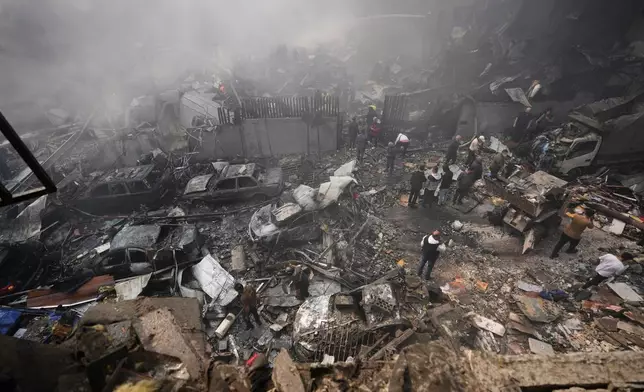 Residents gather at the site of an Israeli airstrike in Beirut, Lebanon, Wednesday, April 8, 2026. (AP Photo/Hussein Malla)