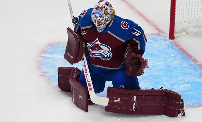 Colorado Avalanche goaltender Scott Wedgewood blocks a shot against the Los Angeles Kings during the first period of Game 1 in the first round of the NHL hockey Stanley Cup playoffs, Sunday, April 19, 2026, in Denver. (AP Photo Jack Dempsey)