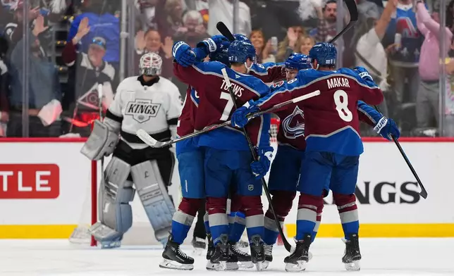 Colorado Avalanche left wing Artturi Lehkonen (partially obscured) celebrates after a goal against Los Angeles Kings goaltender Anton Forsberg, left, with teammates, including Devon Toews (7) and Cale Makar (8), during the second period of Game 1 in the first round of the NHL hockey Stanley Cup playoffs, Sunday, April 19, 2026, in Denver. (AP Photo Jack Dempsey)