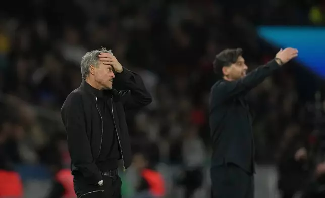 PSG's head coach Luis Enrique, left, reacts during the French League One soccer match between Paris Saint-Germain and Olympique Lyon in Paris, France, Sunday, April 19, 2026. (AP Photo/Christophe Ena)