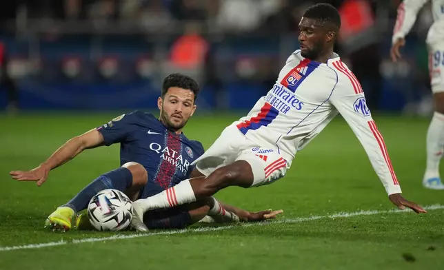 PSG's Goncalo Ramos, left, and Lyon's Clinton Mata challenge for the ball during the French League One soccer match between Paris Saint-Germain and Olympique Lyon in Paris, France, Sunday, April 19, 2026. (AP Photo/Christophe Ena)