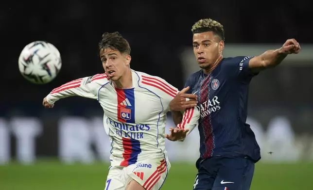 Lyon's Afonso Moreira, left, and PSG's Desire Doue challenge for the ball during the French League One soccer match between Paris Saint-Germain and Olympique Lyon in Paris, France, Sunday, April 19, 2026. (AP Photo/Christophe Ena)