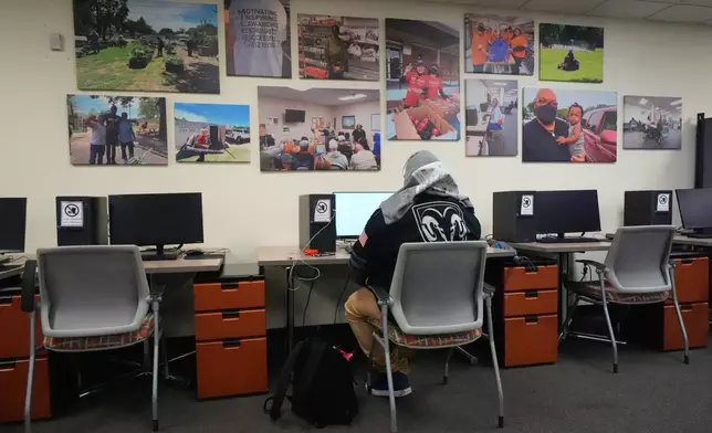 Joe Gorostiza uses a computer at Miles of Freedom, a Dallas-based group that provides help for individuals after they have been released from prison, whether they are on parole or are exonerees, while looking for job opportunities online Tuesday, April 21, 2026 in Dallas. (AP Photo/Julio Cortez)