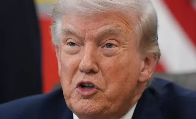 President Donald Trump answers questions from reporters after signing an executive order in the Oval Office of the White House Tuesday, March 31, 2026, in Washington. (AP Photo/Alex Brandon)