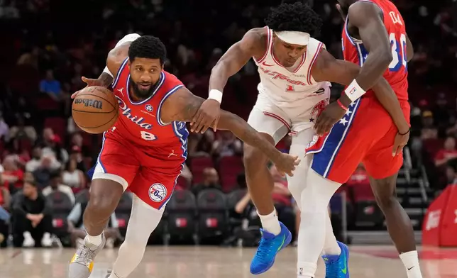 Philadelphia 76ers forward Paul George (8) controls the ball against Houston Rockets guard Amen Thompson (1) who is defended by 76ers center Adem Bona (30) during the first half of an NBA basketball game, Thursday, April 9, 2026, in Houston. (AP Photo/ Karen Warren)